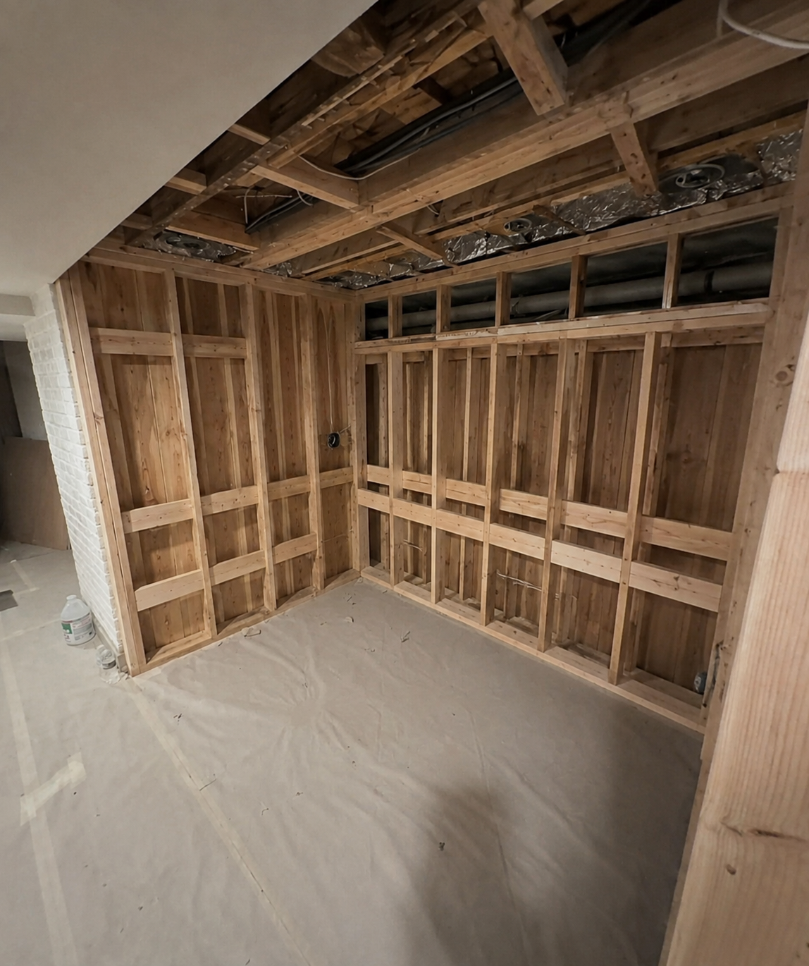 2×4 framing establishes the future glass opening, sauna shell and fixed equipment zones.