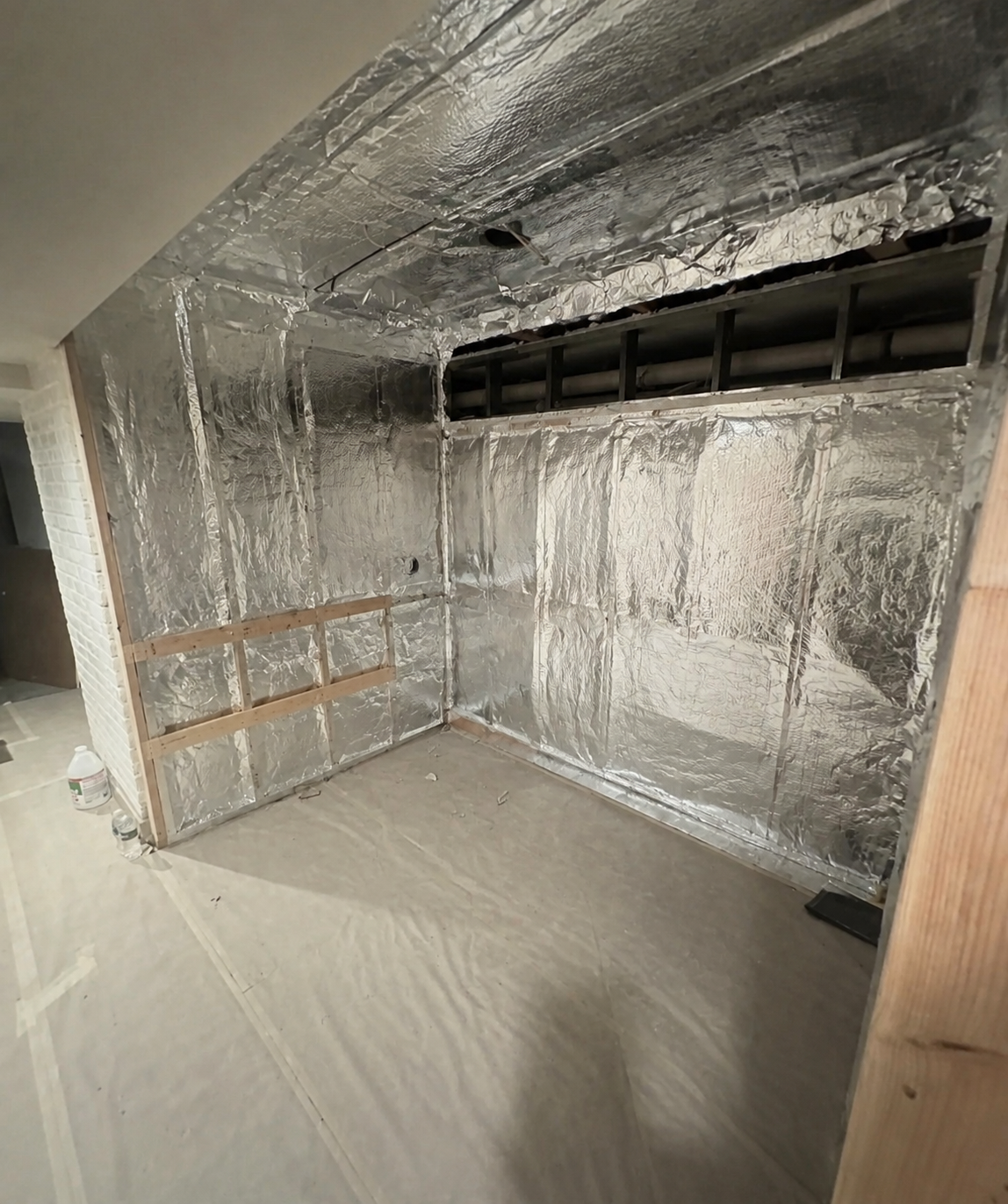 Aluminum-foil vapor barrier with taped seams and initial preparation for furring.