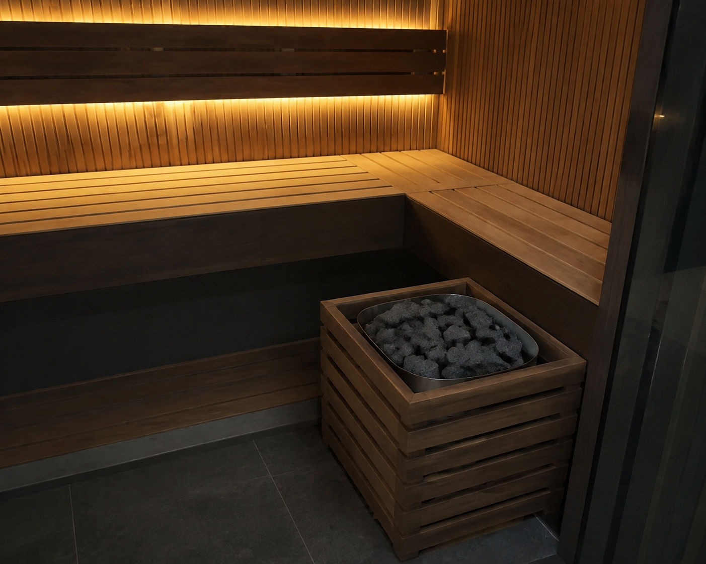 Stone-filled heater in its low wood-slatted guard at the front-right corner.