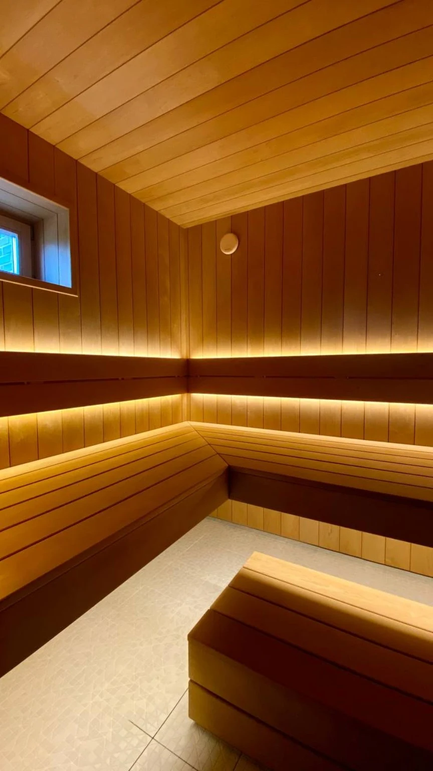 Custom corner benches with a lower step and warm backrest lighting