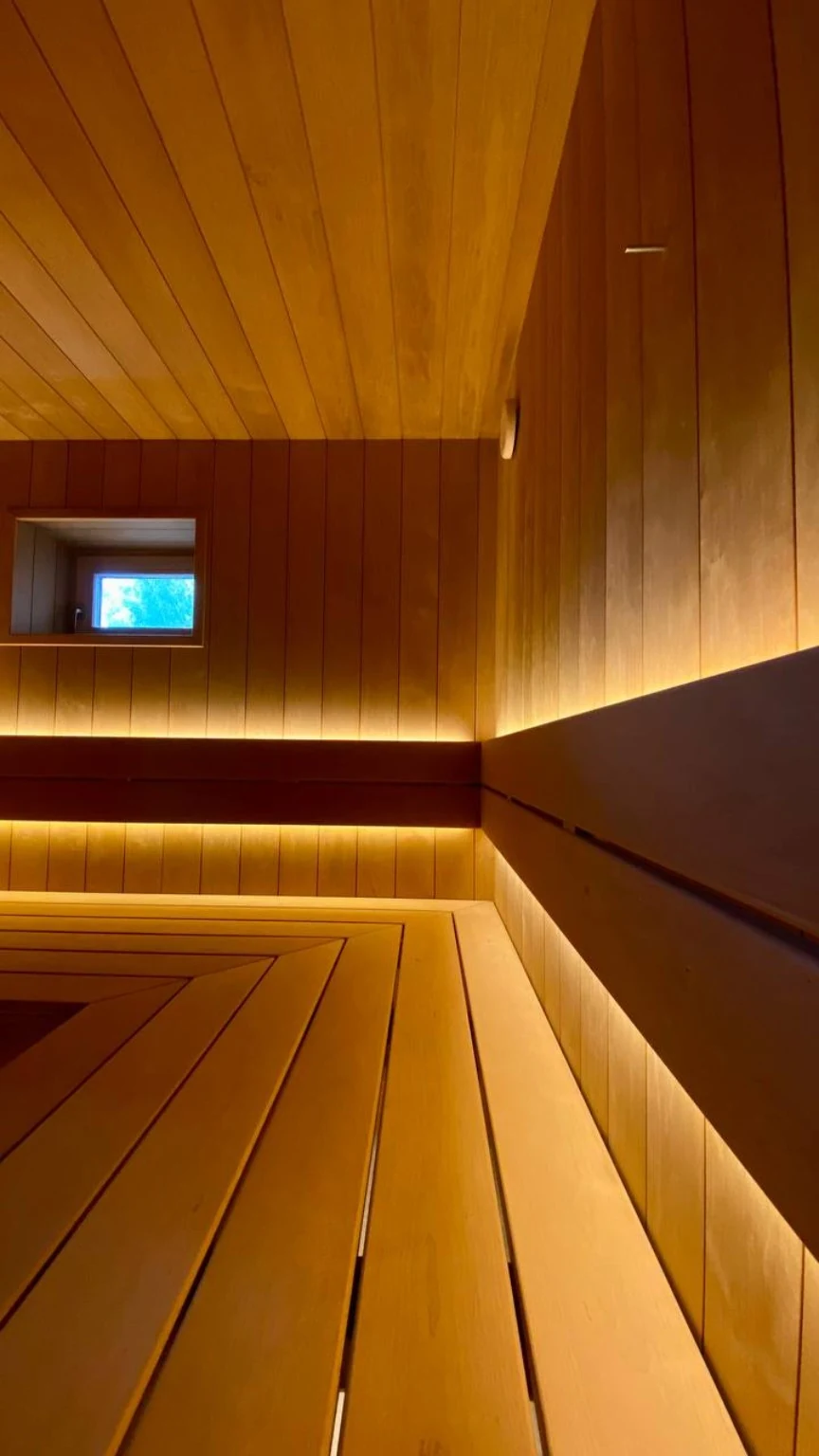 Continuous concealed lighting along the wood backrests