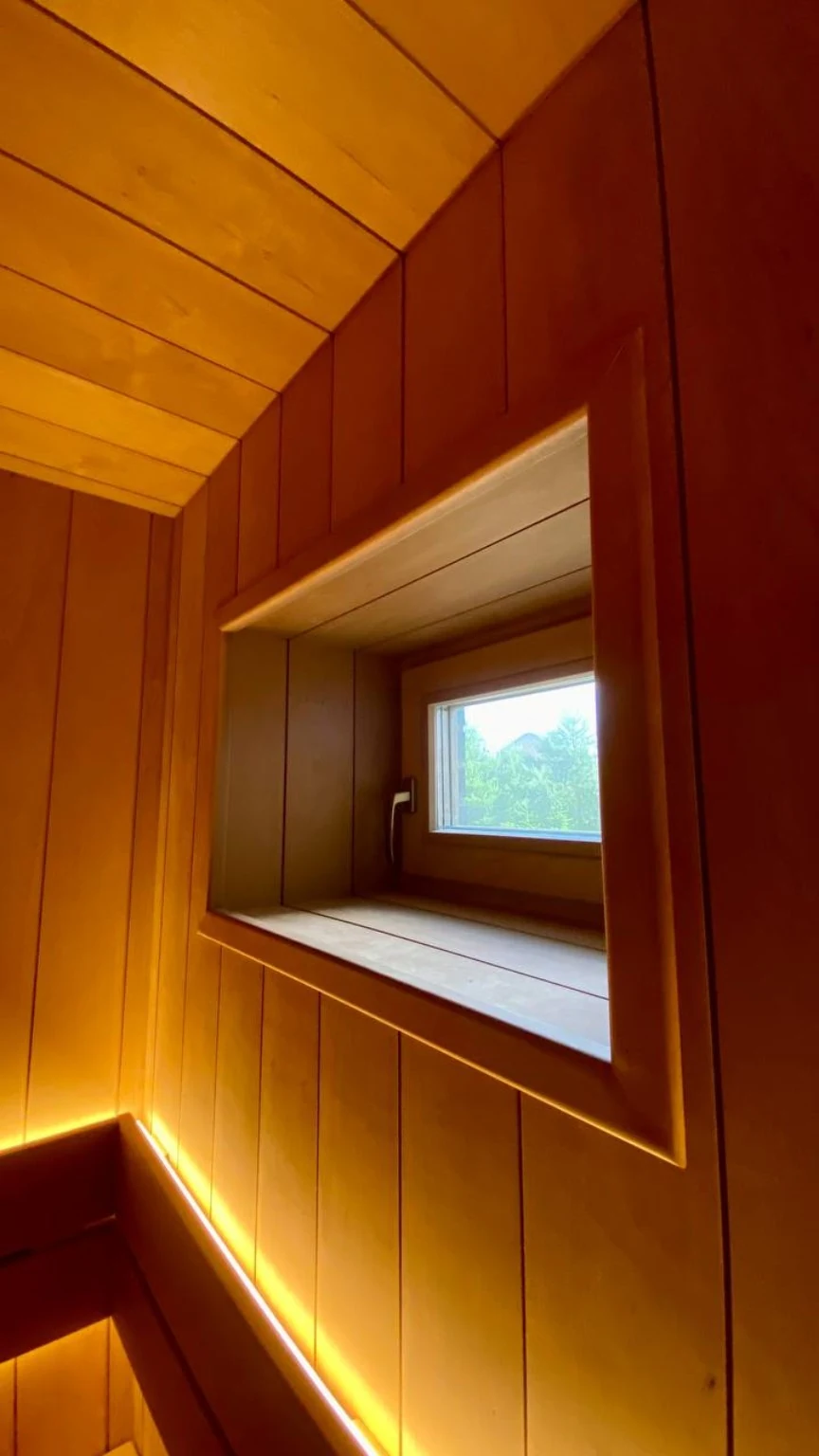 Existing window framed within the vertical wood paneling