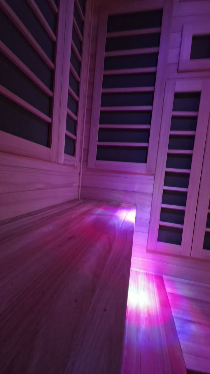 Wood bench detail beside wall-mounted infrared panels
