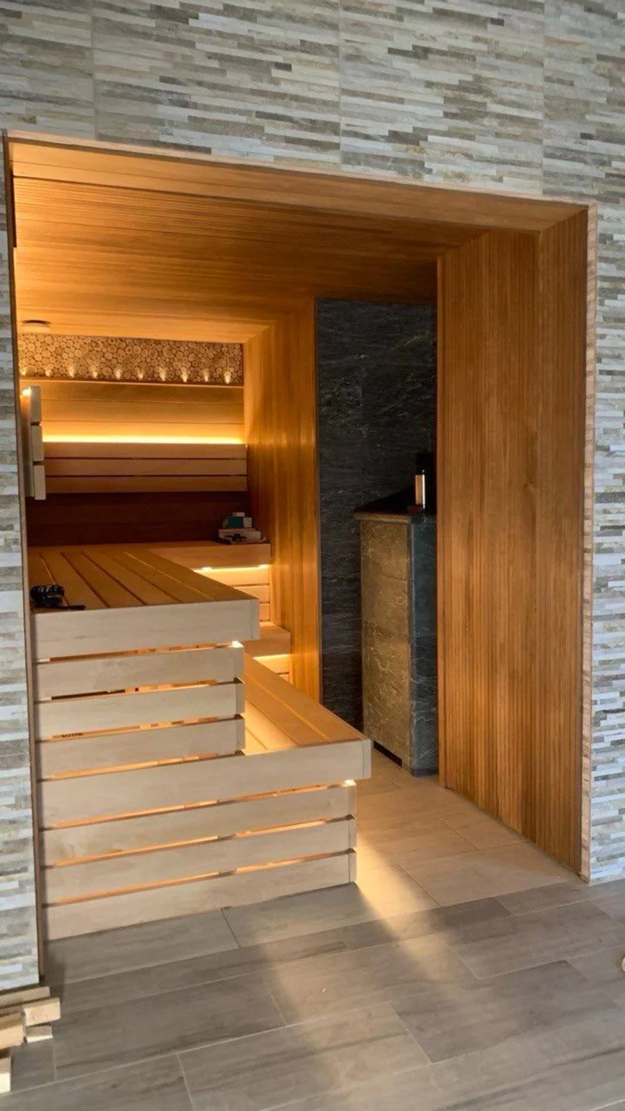 Charlotte basement sauna seen through the stone-framed glass entrance