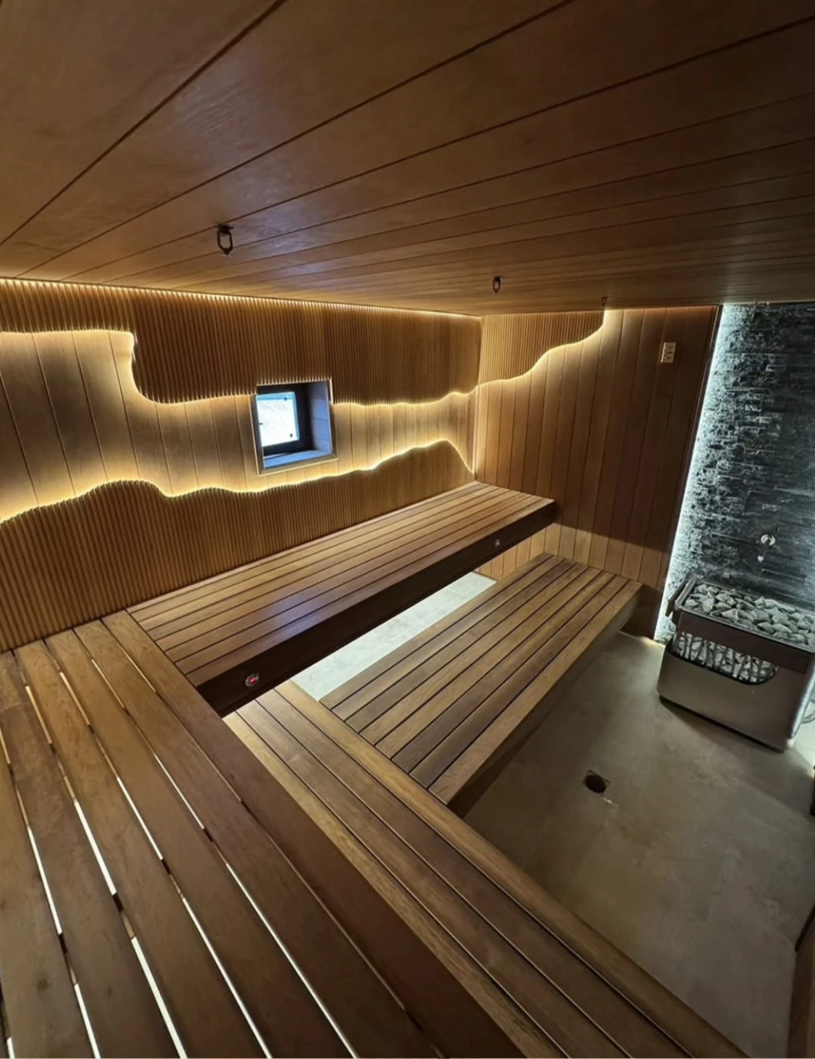 Multi-level benches, illuminated flowing woodwork and a stone heater feature