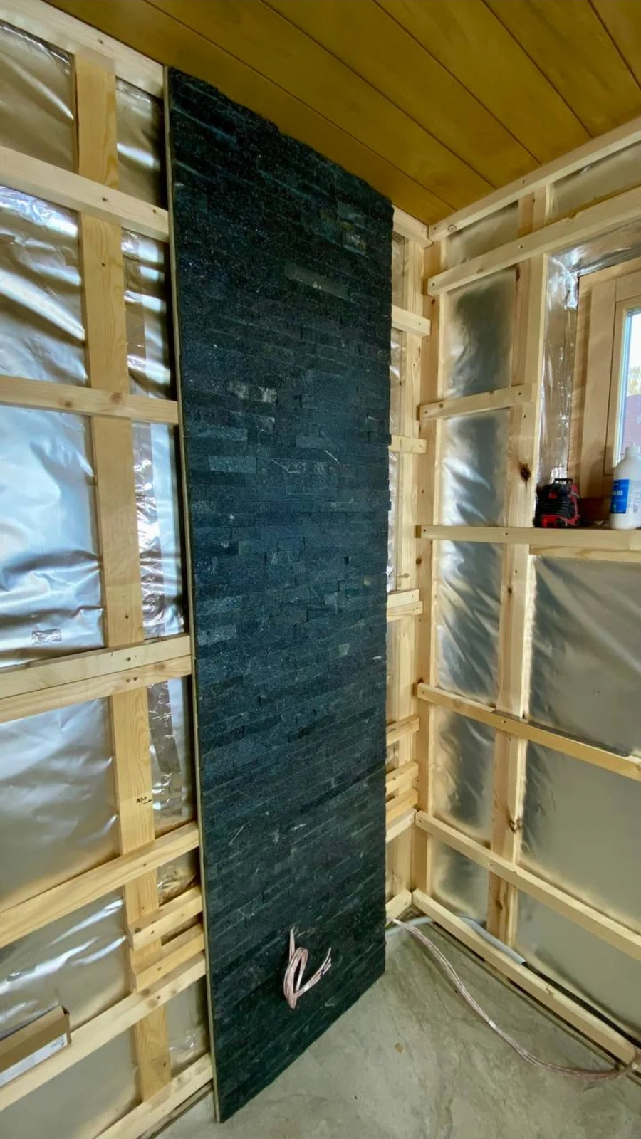 Foil-lined wall framing around the heater recess before finishing