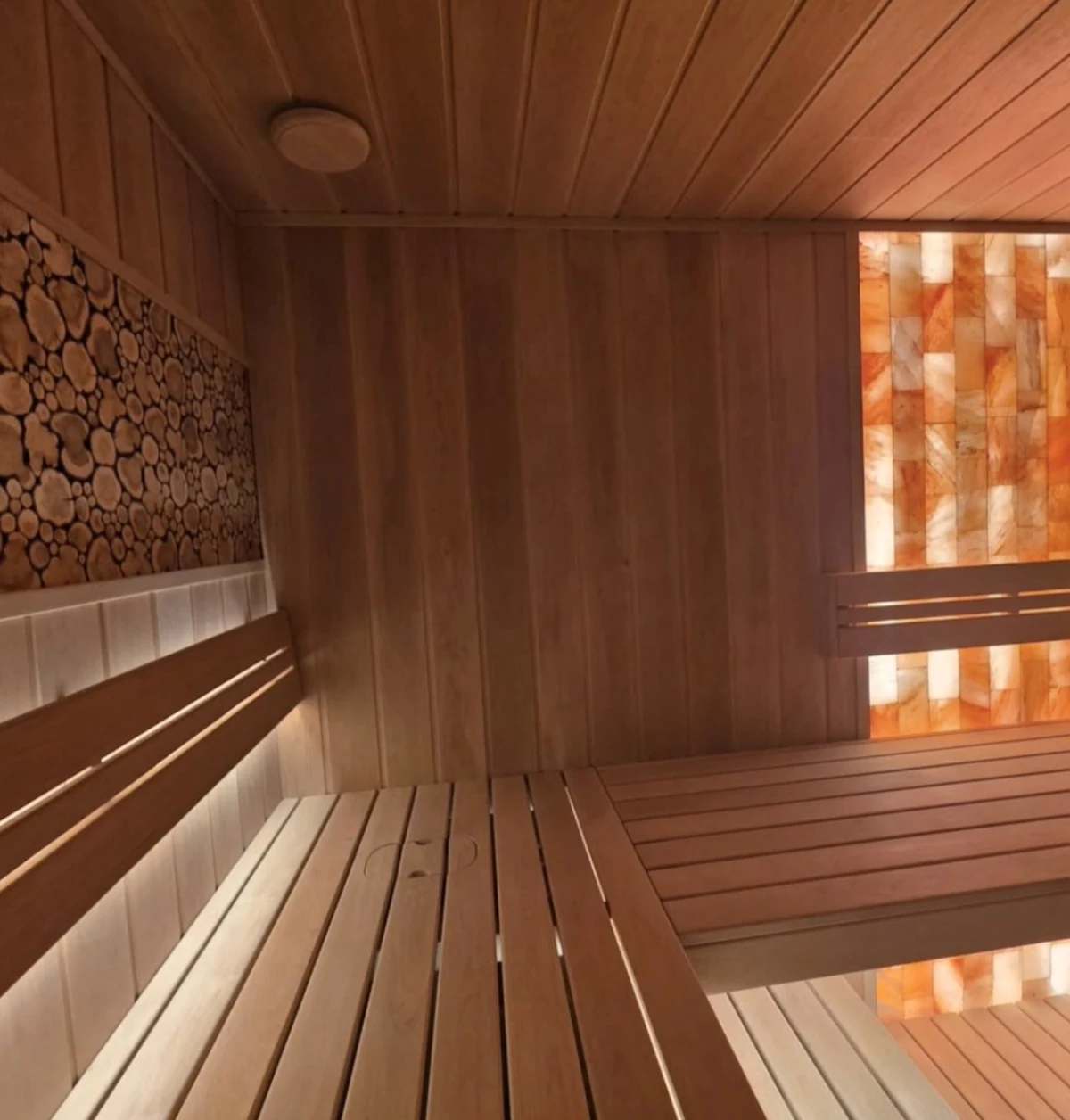 Corner bench layout between the wood-end decorative panel and illuminated salt wall