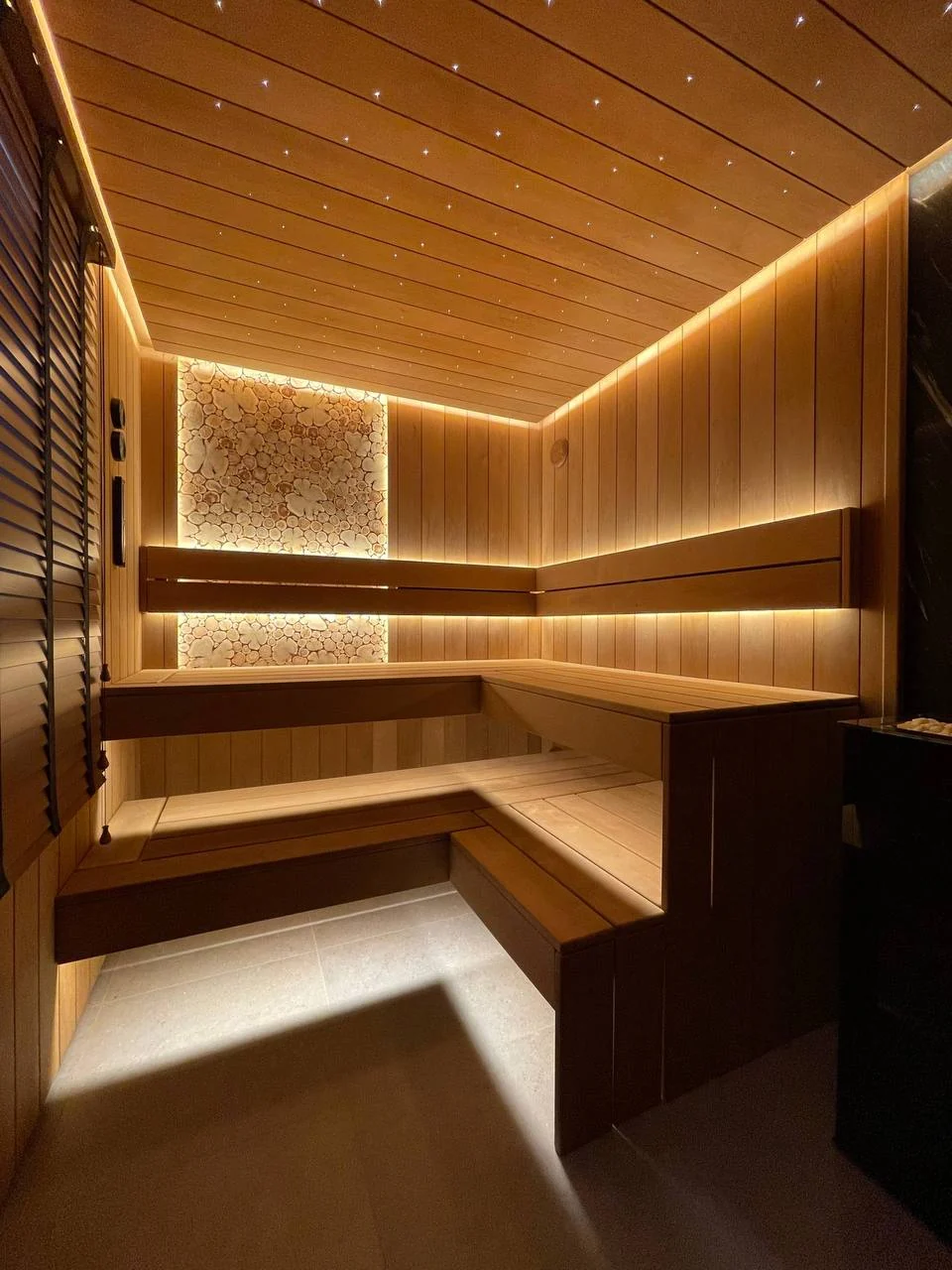 Finished Huntersville sauna with starry ceiling, corner benches and warm lighting