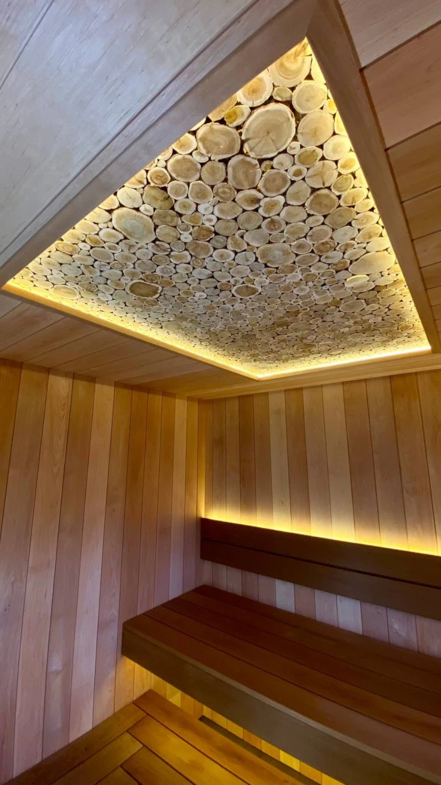 Close view of the illuminated natural wood-slice ceiling panel