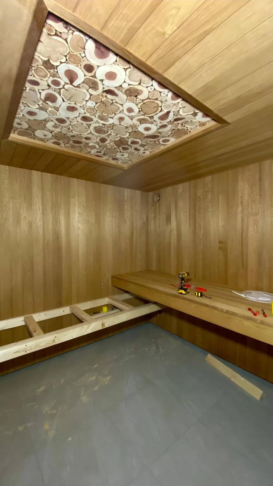 Unfinished bench framing beneath the decorative ceiling panel